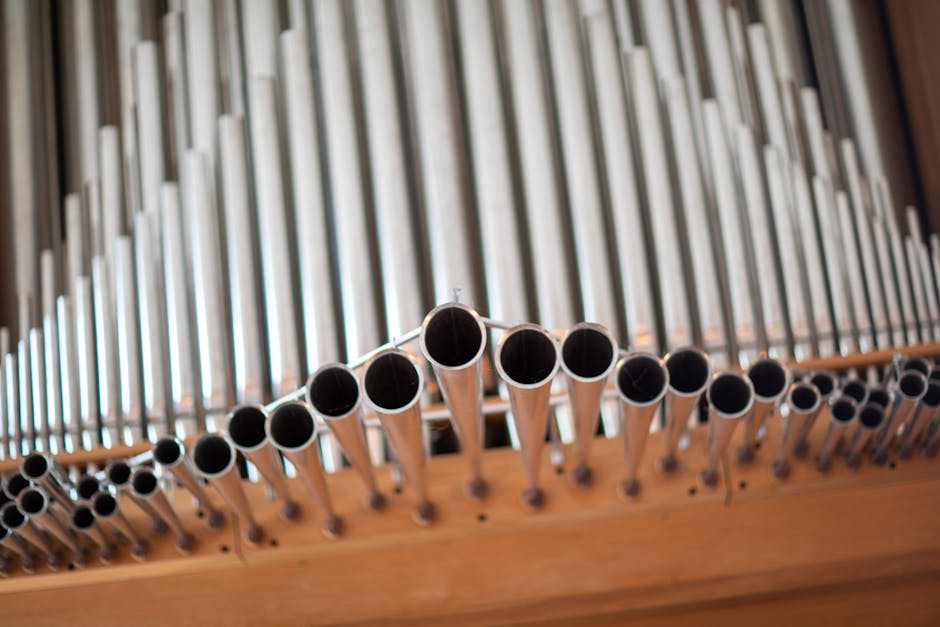 pexels-photo-12189523-12189523 Detailed close-up shot of silver pipe organ tubes with selective focus, a stunning instrument view.